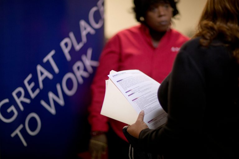 Jimmetta Smith, right, the wife of a U.S. Marine veteran, holds her resume while talking with a senior recruiter for Delta Airlines at a job fair for veterans and their family members at the VFW Post 2681 on Nov. 14 in Marietta, Ga. (AP Photo/David Goldman)