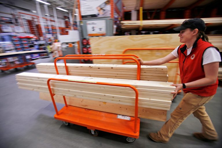 In this May 17, 2014 photo, a shopper checks out with her lumber at a Home Depot in Boston. The Conference Board reports on consumer confidence in August on Tuesday, Aug. 26, 2014. (AP Photo/Gene J. Puskar)