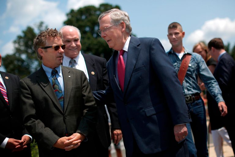 Mitch McConnell (R) greets Sen. Rand Paul (L) at a news conference. Benton admitted that he was 