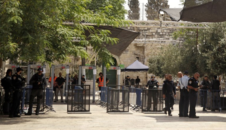 Israeli border police officers stand near newly installed cameras at the entrance to the Al Aqsa Mosque compound, in Jerusalem's Old City, Sunday, July 23, 2017. (AP Photo/Mahmoud Illean)