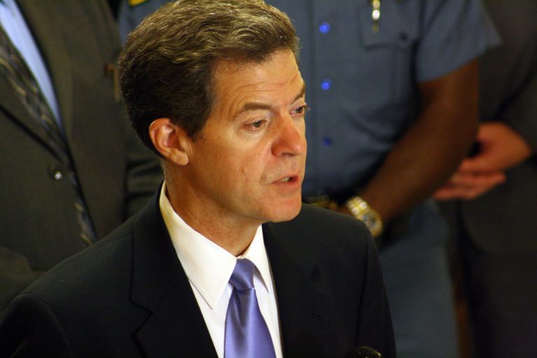 Kansas Gov. Sam Brownback discusses his reasons for calling a special session of the Legislature during a ceremony, Tuesday, Aug. 6, 2013, at the Statehouse in Topeka, Kan. The governor says it's necessary of lawmakers to rewrite the state's 