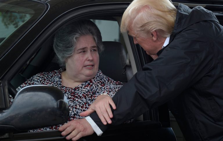 President Donald Trump talks with a woman after loading her car with donated items for people impacted by Hurricane Harvey during a visit to First Church of Pearland in Pearland, Texas, Saturday, Sept. 2, 2017. Trump is also facing pressure internationally on trade. (AP Photo/Susan Walsh)