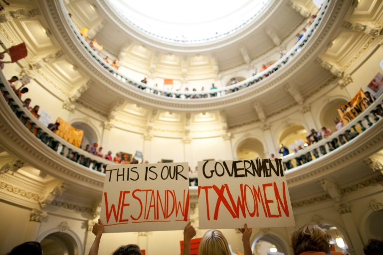FILE - In this July 12, 2013, file photo, abortion rights supporters rally on the floor of the State Capitol rotunda in Austin, Texas. A sharply divided Supreme Court on Tuesday, Nov. 19, 2013, allowed Texas to continue enforcing abortion restrictions that opponents say have led more than a third of the state's clinics to stop providing abortions. (AP Photo/Tamir Kalifa, File)