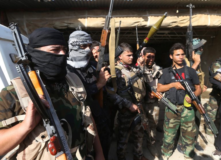 Iraqi Shiite Turkmen gunmen gather as they prepare to patrol around the village of Taza Khormato in the northern oil rich province of Kirkuk, in this picture taken Friday, June 20, 2014. (AP Photo/Hussein Malla)