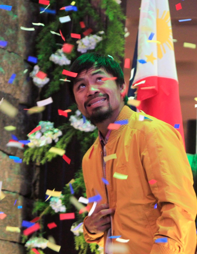   Confetti rain on Filipino boxer and Congressman Manny Pacquiao during a news conference upon arrival in Manila, Philippines, early Saturday, June 16, 2012 from Los Angeles. Pacquiao, who lost his WBO welterweight title to American Timothy Bradley via a controversial split decision June 9, arrived Saturday to check the situation in his home province of Sarangani in southern Philippines following flooding that affected thousands of residents. (AP Photo/Bullit Marquez)  