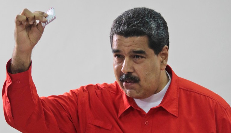 Venezuela's President Nicolas Maduro shows his ballot after casting a vote for a constitutional assembly in Venezuela on Sunday. The Trump administration imposed sanctions on Maduro on Monday following what it called a 