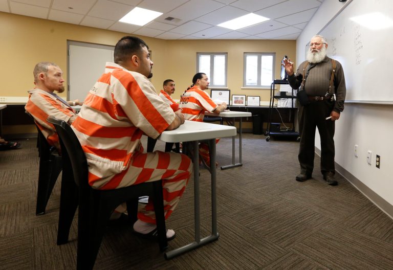 FILE -- In this March 25, 2014 photo, Michael Atinsky, right, leads a discussion group for inmates at the new 192-bed facility at the Stanislaus County Jail in Modesto, Calif.  In an effort to save money on state prison spending, shoplifting, forgery, fraud and petty theft and other lower-level offenses will be treated as misdemeanors if Proposition 47 is approved by voters in November.(AP Photo/Rich Pedroncelli, file)