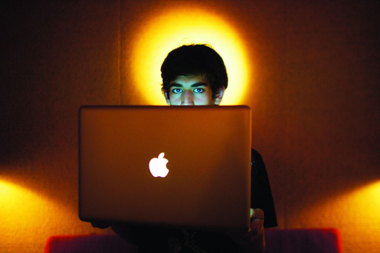 In this Jan. 30, 2009 photo, Internet activist Aaron Swartz poses for a photo in Miami Beach, Fla. Swartz was found dead Friday, Jan. 11, 2013, in his Brooklyn, N.Y., apartment, according to Ellen Borakove, spokeswoman for New York's medical examiner. Swartz, 26, was scheduled to face trial on hacking charges in a few weeks. (AP Photo/The New York Times, Michael Francis McElroy) MANDATORY CREDIT; NYC OUT; MAGS OUT; NO SALES; TV OUT, NO ARCHIVE