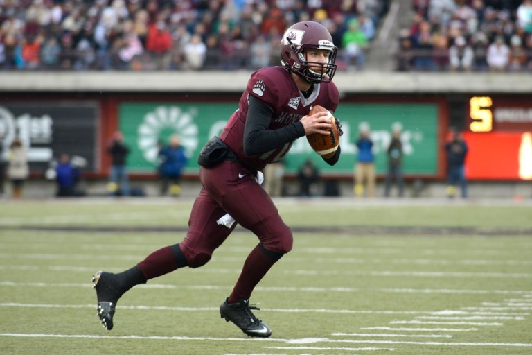 Jordan Johnson, the former starting quarterback for the University of Montana, has reached a settlement with the University of Montana for $245,000 to drop his claims against the university. (AP File Photo/Lido Vizzutti)
