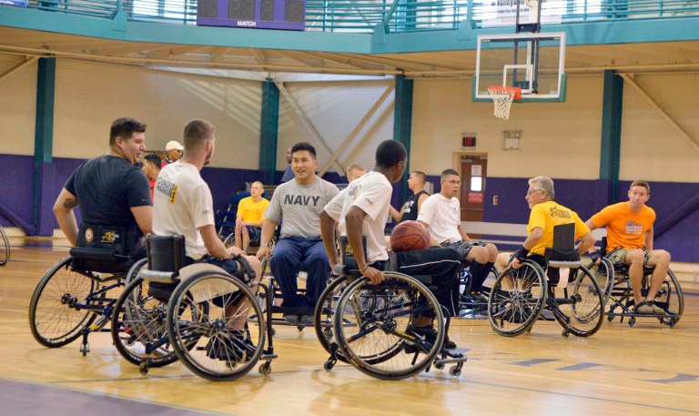 This Sunday June 1, 2014  US Navy photo shows sailors, Coast Guardsmen and coaches in the 2014 Wounded Warrior Team Navy Trials hone their court-skills during a practice session in the Q-80 Sports Complex on board Naval Station Norfolk. Wounded Warrior athletes began arriving in Norfolk on Friday and have until Tuesday evening to work on their individual events before the games begin on June 4.  The Navy Trials are a precursor to the Warrior Games, an annual event athletic competition hosted by the U.S. Olympic Committee that brings together more than 200 wounded warriors from all branches of military service.  Forty Sailors will compete on Team Navy in Colorado Springs later this year.  (AP Photo/U.S. Navy, Capt. Jane Campbell)