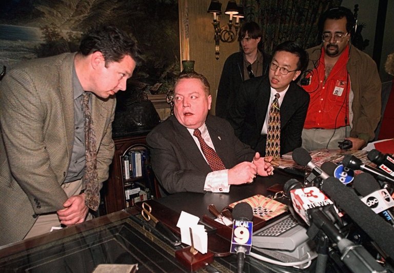 Larry Flynt, Hustler magazine publisher, is surrounded by reporters Friday, Dec. 18, 1998 Los Angeles. Flynt claimed he has gathered evidence showing that Rep. Bob Livingston has had possibly a dozen extramarital affairs within the past 10 years. Flynt said Livingston's admission of adultery was prompted by Flynt's discoveries. (AP Photo/Kevork Djansezian)