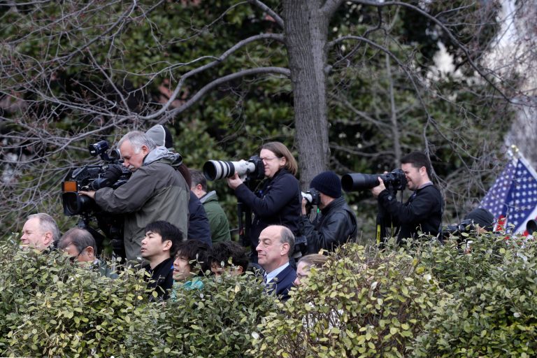 Reporters and photographers stand on the North Lawn of the White House in Washington, Friday, March 1, 2013, as they try to catch a glimpse of congressional leaders arriving on West Executive Avenue for a closed press meeting with President Obama. (AP File)