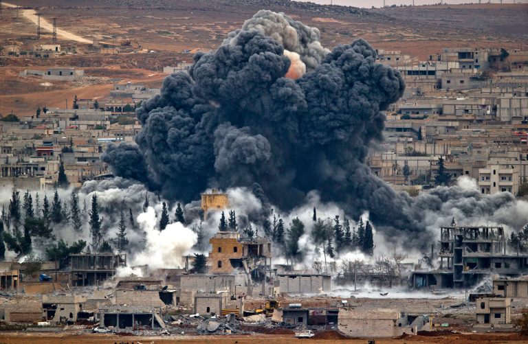 Smoke rises from the Syrian city of Kobani, following an airstrike by the U.S.-led coalition. (AP Photo/Vadim Ghirda, File)