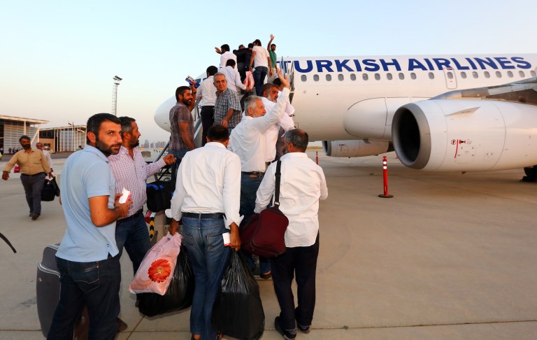 Turkish truck drivers kidnapped by militants in northern Iraq get on board an airplane at an airport in Irbil, north of Baghdad, Iraq, Thursday, July 3, 2014. Militants released the 32 Turkish truck drivers who were captured when the extremists overran the city of Mosul. Militants seized them on June 9 in Mosul, Iraq's second-largest city. Three days later, they took another 49 people from the Turkish consulate in the city. Turkish Foreign Minister Ahmet Davutoglu said efforts were underway to secure the release of the Turks still in captivity. (AP Photo)