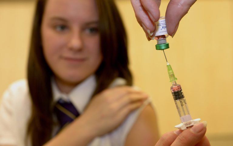 In this photo Thursday, April 25, 2013 Lucy Butler,15, getting ready to have her measles jab at All Saints School in Ingleby Barwick, Teesside, England, as a national vaccination catch-up campaign has been launched to curb a rise in measles cases in England. More than a decade ago, British parents refused to give measles shots to at least a million children because of a vaccine scare that raised the specter of autism. Now, health officials are scrambling to catch up and stop a growing epidemic of the contagious disease. (AP Photo/Owen Humphreys, PA) UNITED KINGDOM OUT - NO SALES - NO ARCHIVES