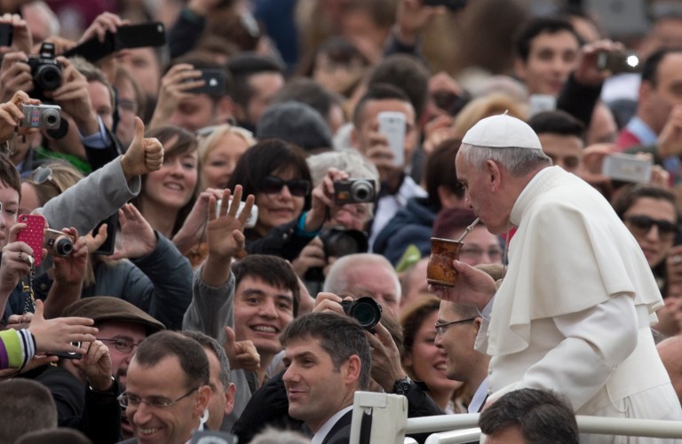 Pope Francis Pope drinks from a mate gourd, a traditional South American cup, we was offered as he is driven through the crowd in St. Peter's Square at the Vatican, prior to his general audience, Wednesday, Feb. 19, 2014.  At public appearances, people offer Pope Francis gifts, and personal belongings to be blessed. (AP Photo/Alessandra Tarantino)