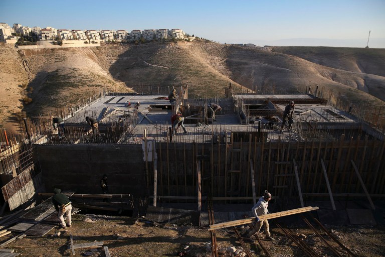 Palestinian laborers work at a construction site in a new housing project in the Israeli settlement of Maale Adumim. (AP Photo/Oded Balilty)