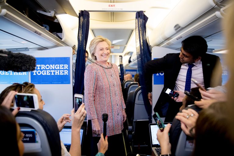Democratic presidential candidate Hillary Clinton laughs with members of her press corps on her campaign plane, in White Plains, N.Y., Thursday, Sept. 15, 2016. (AP Photo/Andrew Harnik)