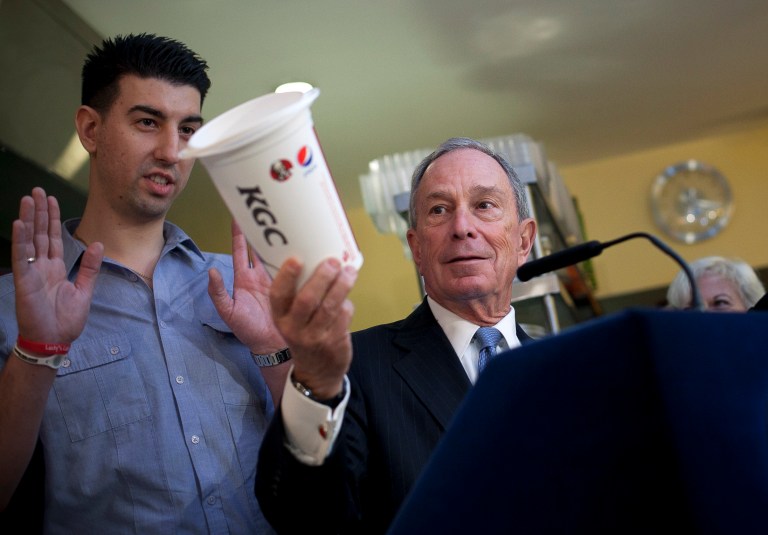 NEW YORK, NY - MARCH 12:  New York City Mayor Michael Bloomberg holds a large cup as he speaks to the media about the health impacts of sugar at Lucky's restaurant, which voluntarily adopted the large sugary drink ban, March 12, 2013 in New York City. A state judge on Monday blocked Bloomberg's ban on oversized sugary drinks but the Mayor plans to appeal the decision.  (Photo by Allison Joyce/Getty Images)