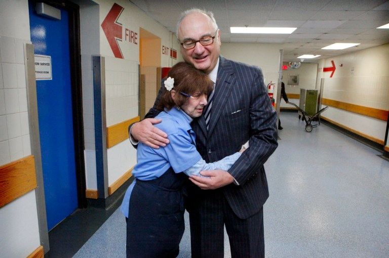   Amway Grand Plaza Hotel CEO Joe Tomaselli gets a hug from Rosemary Paniwozik, a cafeteria server, on Wednesday, Oct. 17, 2012 in the Grand Rapids, Mich. hotel. For the past 25 years, Tomaselli has stayed in a room at the Amway Grand Plaza Hotel while Patty, his wife of 42 years, continued to live at their home in suburban St. Louis. Tomaselli, said he commutes to his hometown several times a month and intends to return there when he retires after Dec. 31. (AP Photo/The Grand Rapids Press, Emily Zoladz) ALL LOCAL TV OUT; LOCAL TV INTERNET OUT  