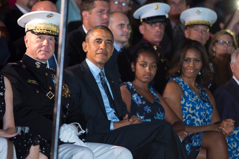 From left, Marine Commandant Gen. James Amos, President Barack Obama, Sasha Obama, and first lady Michelle Obama look on during the Marine Barracks Evening Parade, on Friday, June 27, 2014, in Washington. (AP Photo/ Evan Vucci)