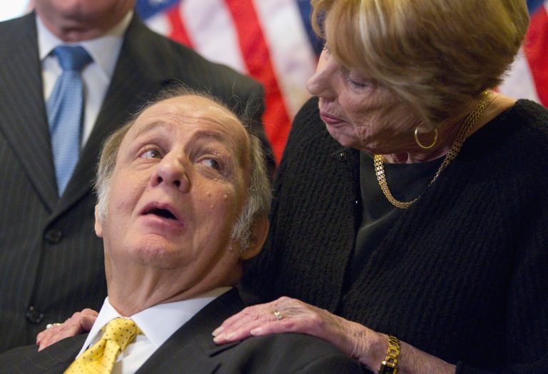 Former White House press secretary James Brady, left, who was left paralyzed in the Reagan assassination attempt, looks at his wife Sarah Brady, during a news conference on Capitol Hill in Washington marking the 30th anniversary of the shooting. A Brady family spokeswoman says Brady has died at 73. (AP Photo/Evan Vucci)