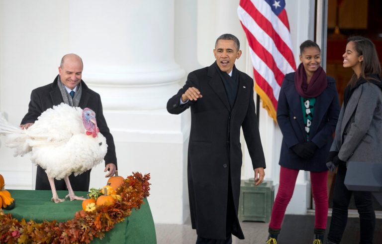 President Barack Obama, with daughters Sasha, second from right, and Malia, right, waves as he leaves after continuing the Thanksgiving tradition of saving Popcorn the turkey from the dinner table with a 