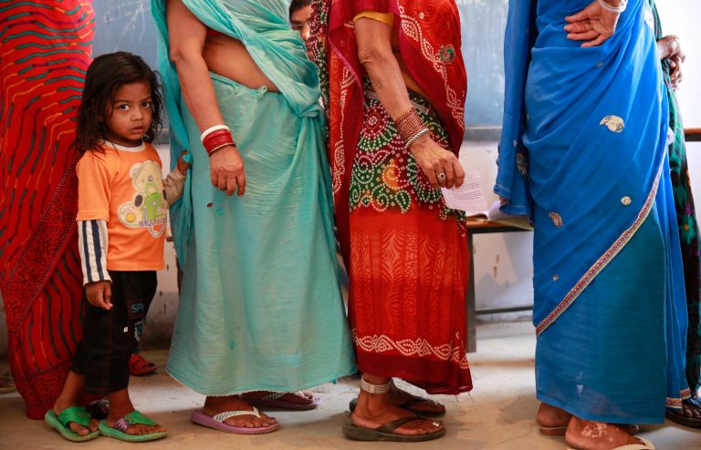 A child holds on to the sari of her grandmother standing in a queue to cast her vote in Rajnandgaon, in the central Indian state of Chhattisgarh, now the center of India's four-decade Maoist insurgency, Thursday, April 17, 2014. Indians cast ballots Thursday on the biggest day of voting in the country's weekslong general election, streaming into polling stations even in areas where rebels threatened violence over the plight of India's marginalized and poor. The state of Chhattisgarh itself was formed only in 2000, carved from its western neighbor Madhya Pradesh based on its large tribal population. (AP Photo/Rafiq Maqbool)