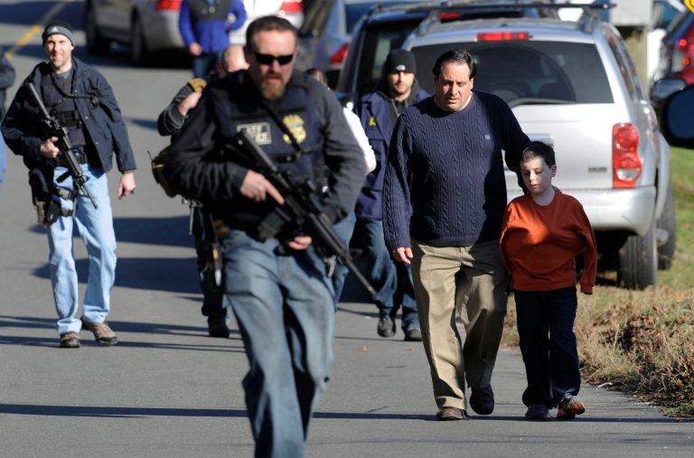   FILE - In this Friday, Dec. 14, 2012 file photo, parents leave a staging area after being reunited with their children following a shooting at the Sandy Hook Elementary School in Newtown, Conn., where Adam Lanza fatally shot 27 people, including 20 children. Psychiatrists say after the grief and fear fades, most of Newtown's young survivors probably will cope without long-term emotional problems, often through play. Among the challenges will be spotting which children are struggling enough that they may need professional help. (AP Photo/Jessica Hill, File)  