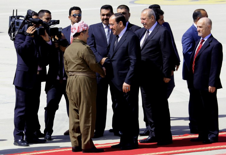 Iraqi Prime Minister Nouri al-Maliki, center right, shakes hands with Kurdish regional President Massoud Barzani, center left, upon his arrival in Irbil, 350 kilometers (217 miles) north of Baghdad, Iraq, Sunday, June 9, 2013. Prime Minister Nouri al-Maliki landed in Iraq's self-ruled northern Kurdish region to hold a Cabinet meeting as part of an initiative started last year to hold meetings outside Baghdad to better understand the needs of the provinces. (AP Photo/Ceerwan Aziz)