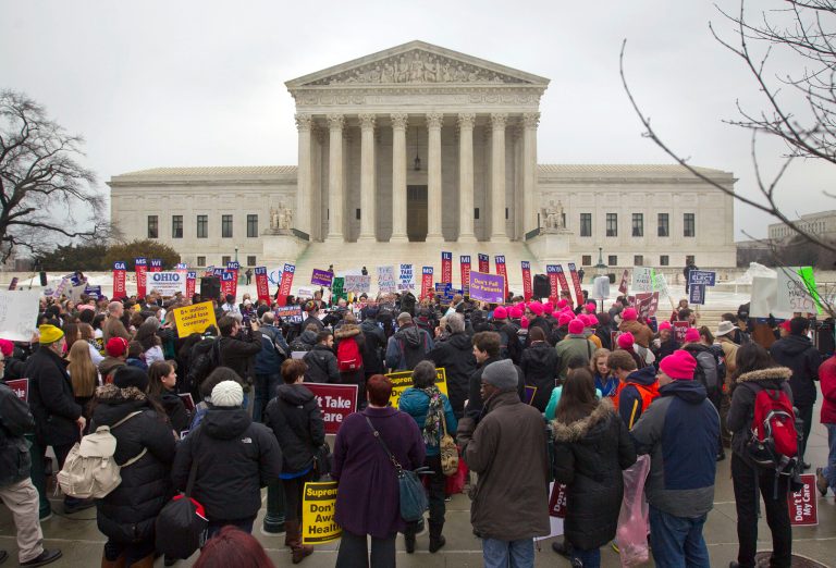 A crowd gathers outside the Supreme Court in Washington, as the court hears arguments in King v. Burwell. (AP Photo/Pablo Martinez Monsivais, File)