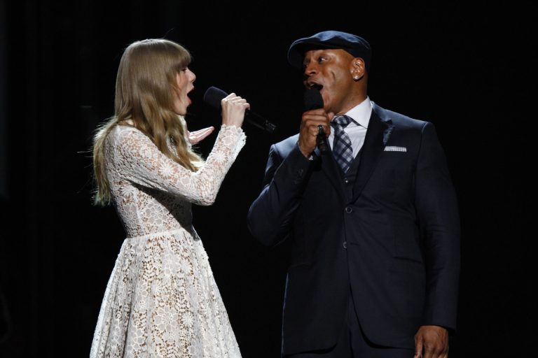   Hosts Taylor Swift, left, and LL Cool J sing onstage at the Grammy Nominations Concert Live! at Bridgestone Arena on Wednesday, Dec. 5, 2012, in Nashville, Tenn. (Photo by Wade Payne/Invision/AP)  