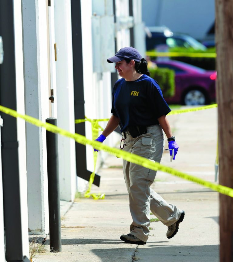An FBI agents enters Arc Electronics Inc. Wednesday, Oct. 3, 2012 in Houston. A Kazakhstan-born businessman was charged in the U.S. on Wednesday with being a secret Russian agent involved in a scheme to illegally export microelectronics from the United States to Russian military and intelligence agencies. (AP Photo/David J. Phillip)