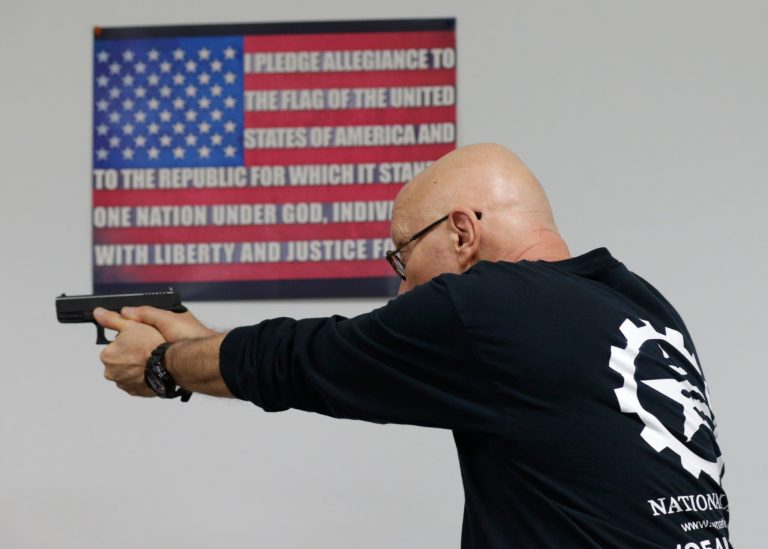 Mike Weinstein, director of training and security at the National Armory gun store and gun range, shows how to safely fire a Glock 9mm hand gun during a Concealed Weapons Permit class on Tuesday, Jan. 5, 2016, in Pompano Beach, Fla. (AP Photo/Lynne Sladky)