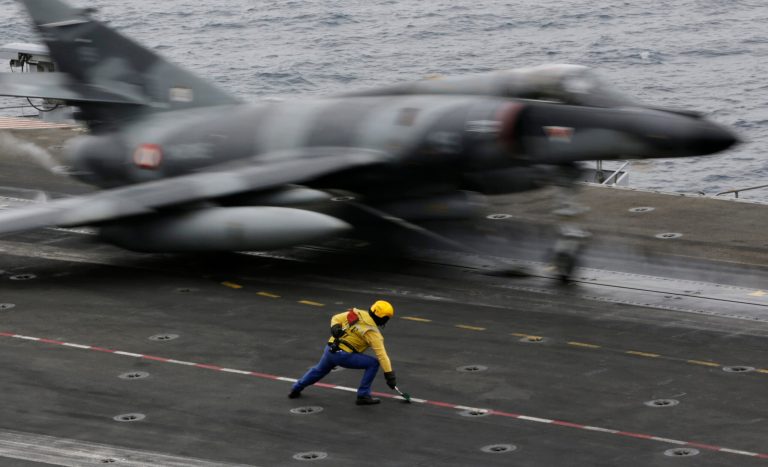A French military plane takes off from the flight deck of the French Navy aircraft carrier Charles de Gaulle Tuesday, March 17, 2015, in the Persian Gulf. Aircraft aboard the French carrier are flying bombing and reconnaissance missions as part of a U.S.-led coalition targeting Islamic State militants in Iraq. (AP Photo/Hasan Jamali)