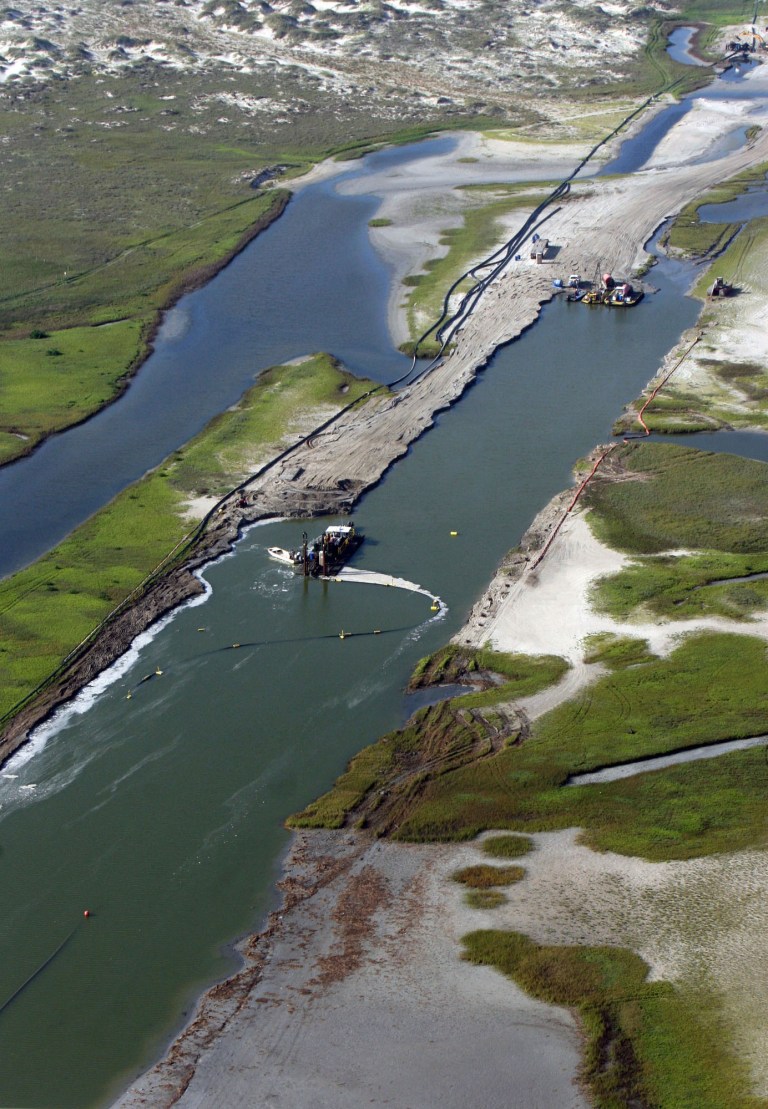 The contractor in charge of the nearly $10 million dredging of Cedar Bayou north of Rockport, Texas announced last week July 28, 2014 the job is about 75 percent complete on the 1.6 mile project. The channel could be flowing by September, which is about a month earlier than the project's Oct. 15 deadline set by the U.S. Army Corps of Engineers. (AP Photo/Corpus Christi Caller-Times, David Sikes)