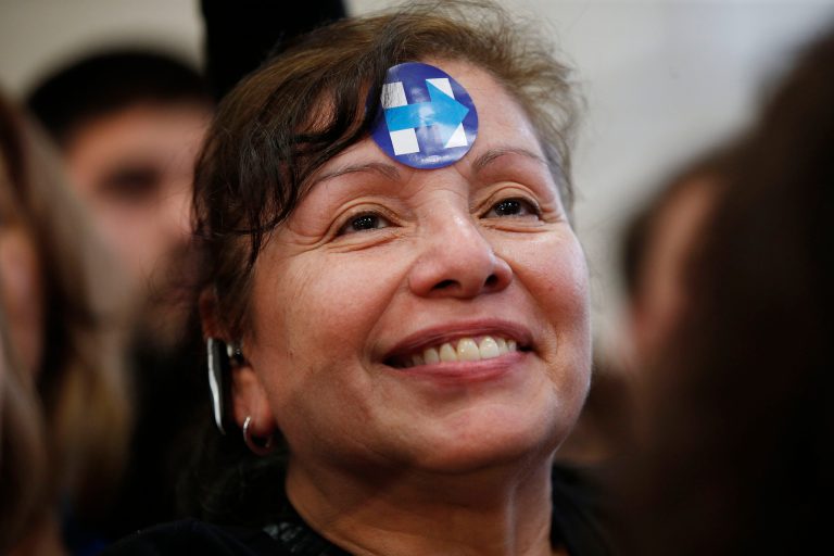 A woman listens to Democratic presidential candidate Hillary Clinton speak at a rally at Hartnell College, Wednesday, May 25, 2016, in Salinas, Calif. (AP Photo/John Locher)