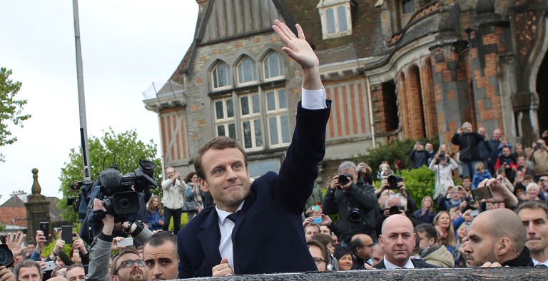 French independent centrist presidential candidate Emmanuel Macron, center, waves as he leaves the polling station after casting his ballot in the presidential runoff election in Le Touquet, France, Sunday, May 7, 2017. (AP Photo/Thibault Camus)