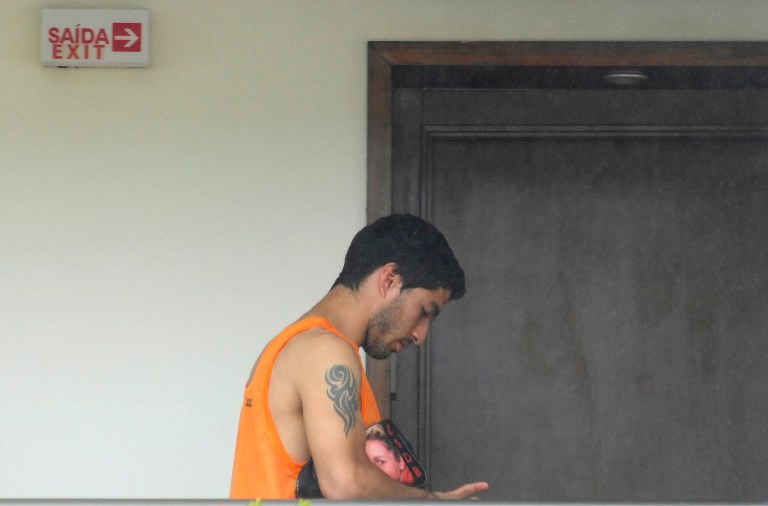 Uruguay striker Luis Suarez is seen at the Serhs Hotel in Natal, Brazil, Thursday, June 26, 2014.  FIFA banned Suarez from all football activities for four months on Thursday for biting an opponent at the World Cup, a punishment that rules him out of the rest of the tournament. (AP Photo/Vlademir Alexandre)
