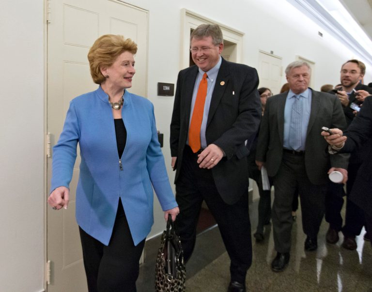 From left, Senate Agriculture Committee Chair Den. Debbie Stabenow, D-Mich., House Agriculture Committee Chairman Rep. Frank Lucas, R-Okla., and Rep. Collin Peterson, D-Minn., ranking Democrat on the House Agriculture Committee, are intercepted by reporters after negations on the Farm Bill wrapped up on Capitol Hill in Washington, Wednesday, Dec. 4, 2013. There is agreement on many parts of the legislation but significant differences remain over funding for the Supplemental Nutrition Assistance Program, more commonly known as food stamps.  (AP Photo/J. Scott Applewhite)