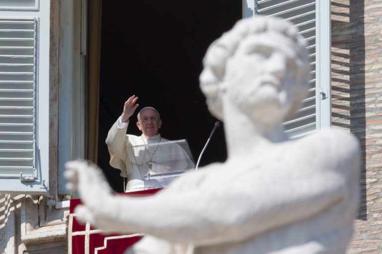 Pope Francis delivers his blessing during the Angelus noon prayer he celebrated from the window of his studio overlooking St. Peter's Square, at the Vatican, Sunday, March 9, 2014. (AP Photo/Andrew Medichini)