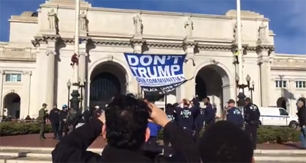 Protesters hang ‘Don’t Trump Our Communities’ banner outside Union Station