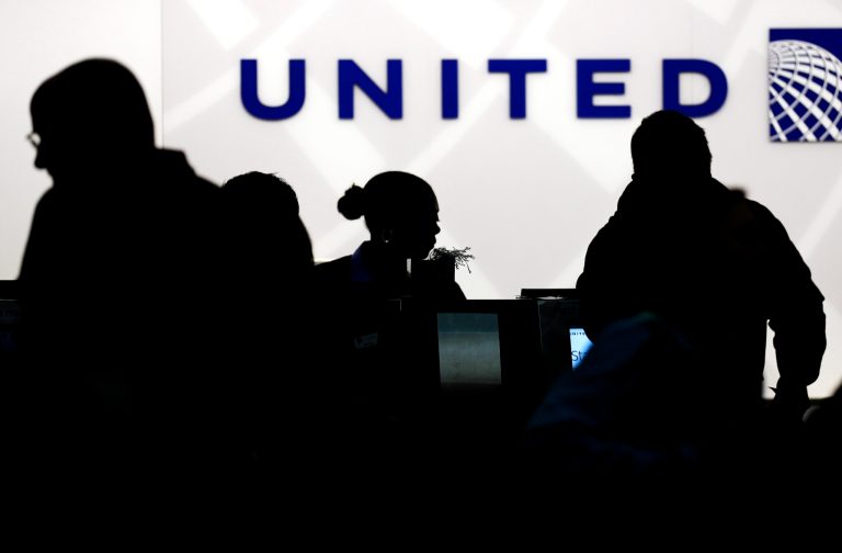 FILE - In this Saturday, Dec. 21, 2013, file photo, Holiday travelers check in at the United Airlines ticket counter at Terminal 1 in O'Hare International Airport in Chicago. United Airlines reports quarterly earnings on Thursday, Jan. 23, 2014. (AP Photo/Nam Y. Huh)