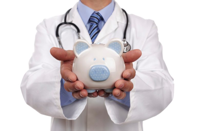 Doctor holding piggy bank