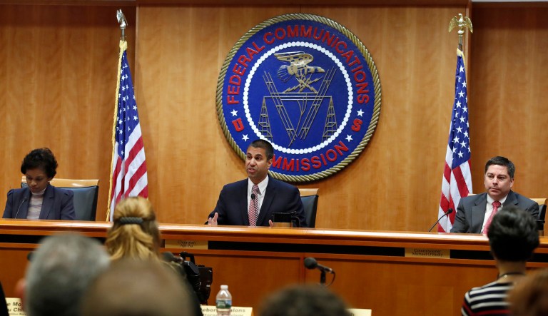 Federal Communications Commission Chairman Ajit Pai, center, announces the vote was approved to repeal net neutrality, next to Commissioner Mignon Clyburn, left, who voted no, and Commissioner Michael O'Rielly, who voted yes, at the FCC, Thursday, Dec. 14, 2017, in Washington. (AP Photo/Jacquelyn Martin)