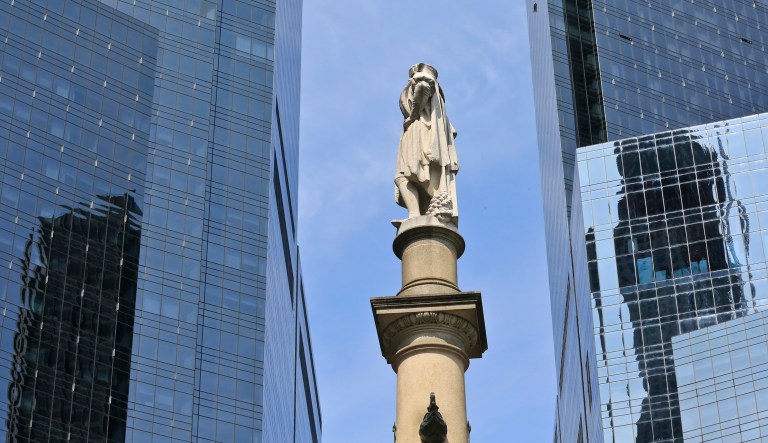 The Christopher Columbus statue is shown at Manhattan's Columbus Circle flanked by the hires complex of the Time Warner Center, Sunday Aug. 27, 2017, in New York. (AP Photo/Bebeto Matthews)