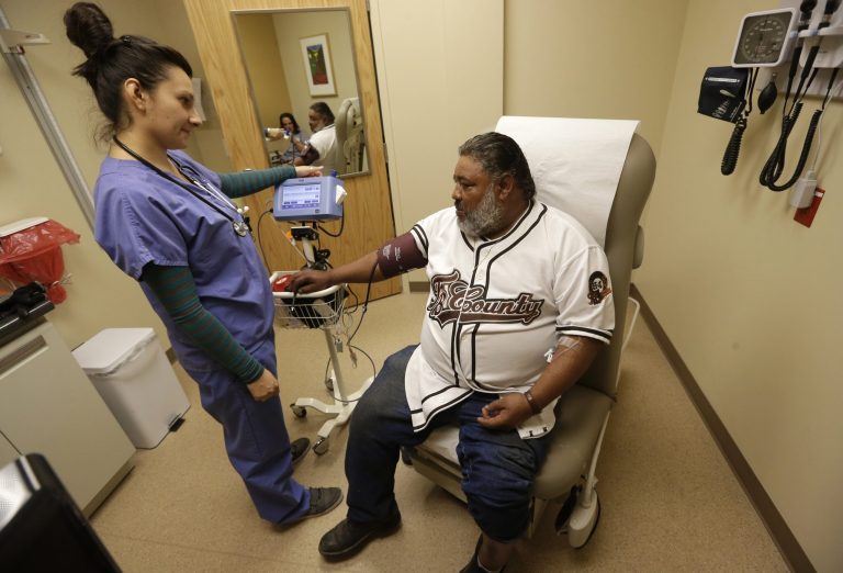 Medical assistant Angelica Colmenero takes the blood pressure of Jose Martinez at the 4th Street Clinic on Wednesday in Salt Lake City. (AP Photo/Rick Bowmer)