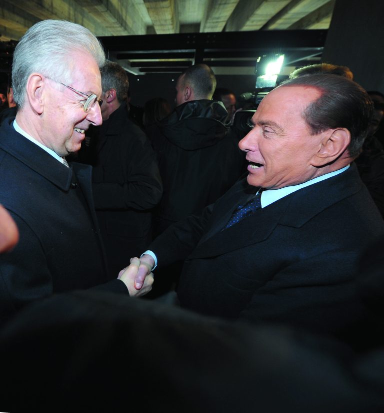 Italian Premier Mario Monti, left, and former Premier Silvio Berlusconi shake hands in Milan, Italy, Sunday, Jan. 27, 2013. Silvio Berlusconi says Benito Mussolini did much good, except for dictator's regime's anti-Jewish laws. Berlusconi also defended Mussolini for siding with Hitler, saying the late fascist leader likely reasoned that German power would expand so it would be better for Italy to ally itself with Germany. He was speaking to reporters Sunday on the sidelines of a ceremony in Milan to commemorate the Holocaust. When Germany's Nazi regime occupied Italy during World War II, thousands from the tiny Italian Jewish community were deported to death camps. In 1938, before the war's outbreak, Mussolini's regime passed anti-Jewish laws, barring them from universities and many professions, among other bans. Berlusconi called the laws Mussolini's 