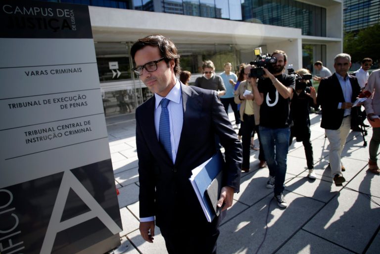 In this July 24, 2014 photo, Francisco Proenca de Carvalho, lawyer for Portuguese bank Banco Espirito Santo's former chief executive Ricardo Salgado, leaves a Lisbon court after Salgado was questioned about money-laundering, fraud and forgery. The Espirito Santo family business survived wars, dictatorship, revolution and family feuds for almost 150 years. Now, one of Europe's last banking dynasties is being stripped of its wealth and influence amid accounting irregularities, huge unreported debts, and a police investigation. (AP Photo/Francisco Seco)