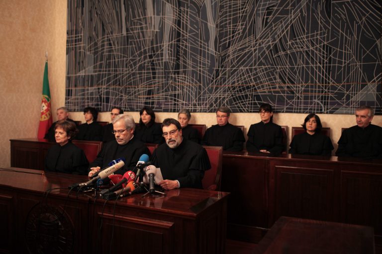 Judge Carlos Cadilha, center right, reads a statement Friday, April 5, 2013, at the Constitutional Court in Lisbon. Portugal's Constitutional Court has ruled that some of the unpopular pay cuts in this year's state budget are unlawful, denying the government about 1.4 billion euros, US dlrs 1.8 billion, of predicted revenue. The court's decision Friday delivers a setback to the austerity strategy agreed between the government and foreign creditors who lent Portugal 78 billion euros, US dlrs 101.5 billion, in a bailout two years ago. (AP Photo/Armando Franca)